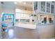 Open kitchen with a breakfast bar, white appliances, and nautical accents throughout the design at 1055 Canary S Cir, Lakeland, FL 33809