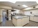 Bright commercial kitchen with stainless steel appliances, a large island, and tiled flooring at 1055 Canary S Cir, Lakeland, FL 33809