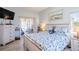 Serene main bedroom with coastal-themed decor, ample natural light, and access to the lanai at 1055 Canary S Cir, Lakeland, FL 33809