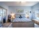 Tranquil main bedroom featuring light blue walls, nautical decor, and a sliding glass door to the patio at 1055 Canary S Cir, Lakeland, FL 33809