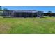 A large backyard featuring a screened in pool at 121 Bonnie Dr, Auburndale, FL 33823