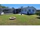 Exterior of home featuring in-ground pool with screened-in lanai at 121 Bonnie Dr, Auburndale, FL 33823