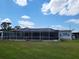 Expansive screened lanai and backyard offering ample space for outdoor enjoyment and relaxation at 121 Bonnie Dr, Auburndale, FL 33823
