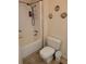 This bathroom features a tub-shower, toilet, and decor accents creating a cozy space at 121 Bonnie Dr, Auburndale, FL 33823