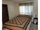 Bright and cozy bedroom features a brass bed, window, and closet space, creating a comfortable and functional living space at 121 Bonnie Dr, Auburndale, FL 33823