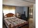 Serene bedroom boasts a comfortable bed, dresser, and a peaceful view, offering a relaxing retreat at 121 Bonnie Dr, Auburndale, FL 33823