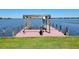 Dock on the lake with a pergola and bench seating at 121 Bonnie Dr, Auburndale, FL 33823