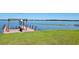Dock on the lake with a pergola and bench seating, on a sunny day at 121 Bonnie Dr, Auburndale, FL 33823