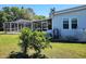Single-story home featuring an enclosed porch and screened-in outdoor living area at 121 Bonnie Dr, Auburndale, FL 33823