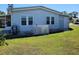 Cozy single-story home featuring an enclosed porch and well-maintained lawn at 121 Bonnie Dr, Auburndale, FL 33823