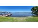 Beautiful lake view with lush green grass and a private dock at 121 Bonnie Dr, Auburndale, FL 33823