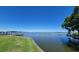 Beautiful lake view with lush green grass and a private dock at 121 Bonnie Dr, Auburndale, FL 33823