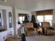 Comfortable living area featuring plush armchairs, built-in shelving, and ample natural light at 121 Bonnie Dr, Auburndale, FL 33823
