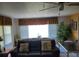 Bright and airy living room featuring comfortable seating, sheer curtains, and natural light at 121 Bonnie Dr, Auburndale, FL 33823