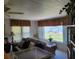 Inviting living room with waterfront view, comfortable seating, and natural light at 121 Bonnie Dr, Auburndale, FL 33823