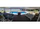 A covered patio overlooks a swimming pool and large lake at 121 Bonnie Dr, Auburndale, FL 33823
