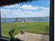 Breathtaking water view from the cozy home, featuring a private dock and lush green lawn extending to the waterfront at 121 Bonnie Dr, Auburndale, FL 33823
