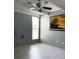 Bedroom with ceiling fan, painting on the wall and white wood-look floor at 1219 Club Cir, Lakeshore, FL 33854