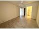 Empty bedroom space with wooden flooring, neutral paint, ceiling fan, and bathroom access at 1219 Club Cir, Lakeshore, FL 33854