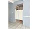 Entryway showing a partial view of a room with swinging doors, and tile flooring at 1219 Club Cir, Lakeshore, FL 33854