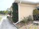 Charming home exterior with lush landscaping and a view of the nearby lake at 1219 Club Cir, Lakeshore, FL 33854