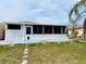Exterior of home with enclosed lanai and privacy fence at 1219 Club Cir, Lakeshore, FL 33854