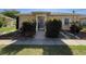 Inviting front entrance of this home with decorative bushes flanking the front walk at 1219 Club Cir, Lakeshore, FL 33854