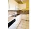 Efficient kitchen with white cabinets, stone backsplash and modern appliances at 1219 Club Cir, Lakeshore, FL 33854