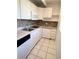 Efficient galley kitchen with white cabinets, appliances, and stylish backsplash at 1219 Club Cir, Lakeshore, FL 33854