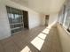 Enclosed sunroom with tile flooring, access to a closet, and sliding glass doors at 1219 Club Cir, Lakeshore, FL 33854