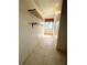 Long sunroom with tiled floors, shelving, a window, and access to the outside at 1219 Club Cir, Lakeshore, FL 33854