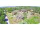 An aerial shot showcases the home and its expansive lot, surrounded by lush greenery at 122 Wgto Tower Rd, Lake Alfred, FL 33850