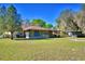 Large backyard with screen enclosed patio, perfect for enjoying the outdoors in comfort at 122 Wgto Tower Rd, Lake Alfred, FL 33850
