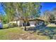 Home with a screened lanai and a large tree in the expansive backyard at 122 Wgto Tower Rd, Lake Alfred, FL 33850