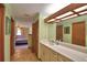 Bathroom with single vanity, decorative mirror, and tile floors at 122 Wgto Tower Rd, Lake Alfred, FL 33850