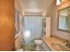Bathroom with blue and white striped shower curtain, sink, toilet, mirror and shelves for storage at 122 Wgto Tower Rd, Lake Alfred, FL 33850
