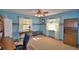 Bedroom featuring blue walls, carpet flooring, fan, two windows and light colored curtains at 122 Wgto Tower Rd, Lake Alfred, FL 33850