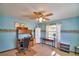 Blue toned bedroom featuring carpet, ceiling fan and a desk at 122 Wgto Tower Rd, Lake Alfred, FL 33850