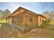 An exterior shot of the screened porch of the home at 122 Wgto Tower Rd, Lake Alfred, FL 33850
