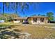 Charming single story home with stone accents, shuttered windows, and mature trees at 122 Wgto Tower Rd, Lake Alfred, FL 33850