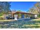 Back exterior of home showing an enclosed sunroom with views of the yard at 122 Wgto Tower Rd, Lake Alfred, FL 33850