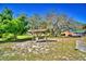 Relaxing covered porch swing with lots of open yard and mature trees for shade at 122 Wgto Tower Rd, Lake Alfred, FL 33850