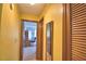 Hallway with yellow walls and wood trim, leading to rooms with wood doors and ample space at 122 Wgto Tower Rd, Lake Alfred, FL 33850