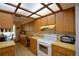 Well-lit kitchen featuring light wood cabinets, tile floors, a breakfast nook, and skylight roof at 122 Wgto Tower Rd, Lake Alfred, FL 33850