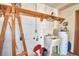 Laundry room with a utility sink, hot water tank, and unfinished walls at 122 Wgto Tower Rd, Lake Alfred, FL 33850