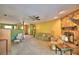 Carpeted living room features a stone fireplace, adjacent green room and staircase at 122 Wgto Tower Rd, Lake Alfred, FL 33850
