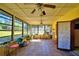 Sunroom featuring many large windows and ceiling fans at 122 Wgto Tower Rd, Lake Alfred, FL 33850