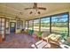 Sunroom featuring tile flooring, large windows, and ceiling fans at 122 Wgto Tower Rd, Lake Alfred, FL 33850