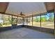Screened-in porch with a fan offers a peaceful view of the lush backyard at 122 Wgto Tower Rd, Lake Alfred, FL 33850