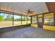 Enclosed patio with a ceiling fan, ample outdoor views and a concrete floor at 122 Wgto Tower Rd, Lake Alfred, FL 33850